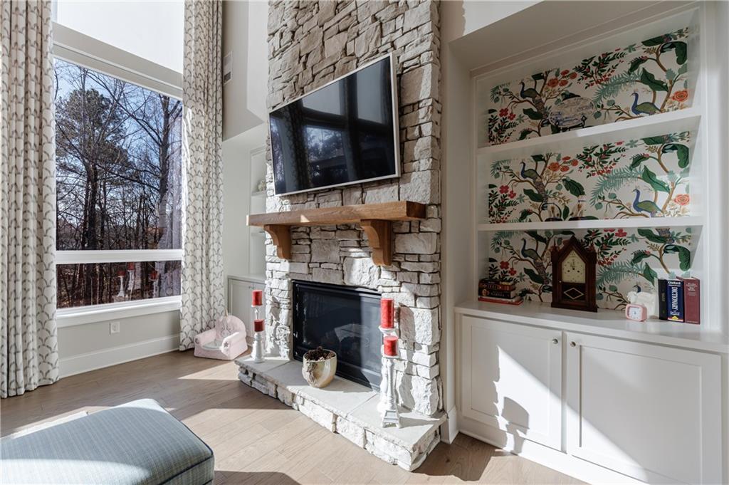 3085 Gray Hawk Lane Roswell, GA 30076 - Photo 30 of 99 a living room with a fireplace and a flat screen tv