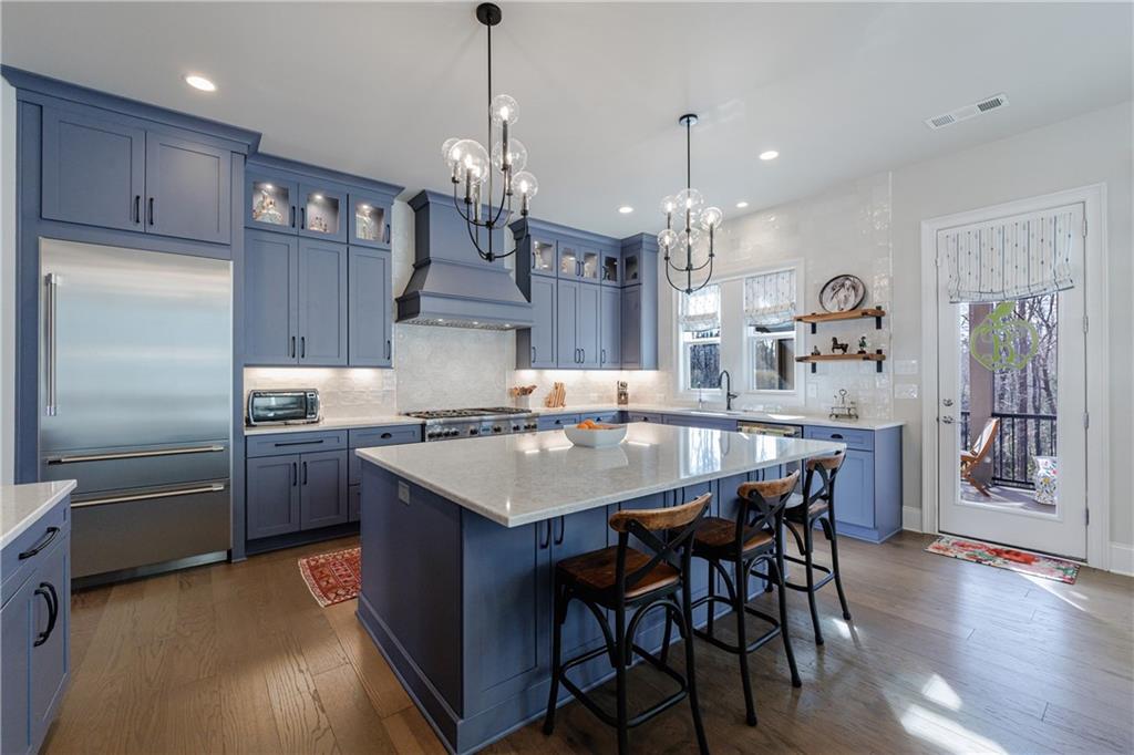 3085 Gray Hawk Lane Roswell, GA 30076 - Photo 4 of 99 a kitchen with stainless steel appliances granite countertop a kitchen island a stove a table and chairs in it