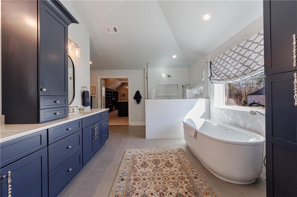 3085 Gray Hawk Lane Roswell, GA 30076 - Photo 45 of 99 a large spacious bathroom with a double vanity sink a mirror and a bathtub