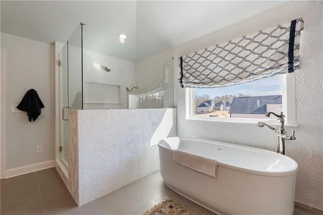 a view of a house with a yard and potted plants