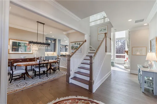 a view of a dining room with furniture wooden floor and chandelier