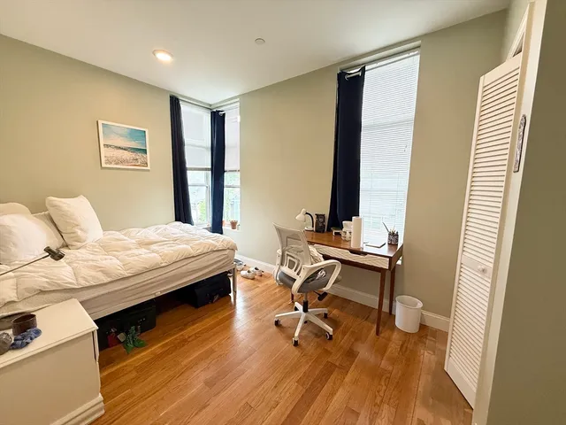 a bedroom with a bed and a desk