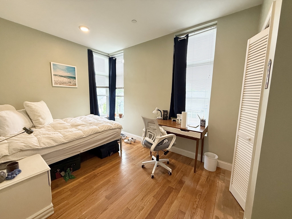 299 Dudley Street, Unit 5 Boston, MA 02119 - Photo 4 of 8 a bedroom with a bed and a desk