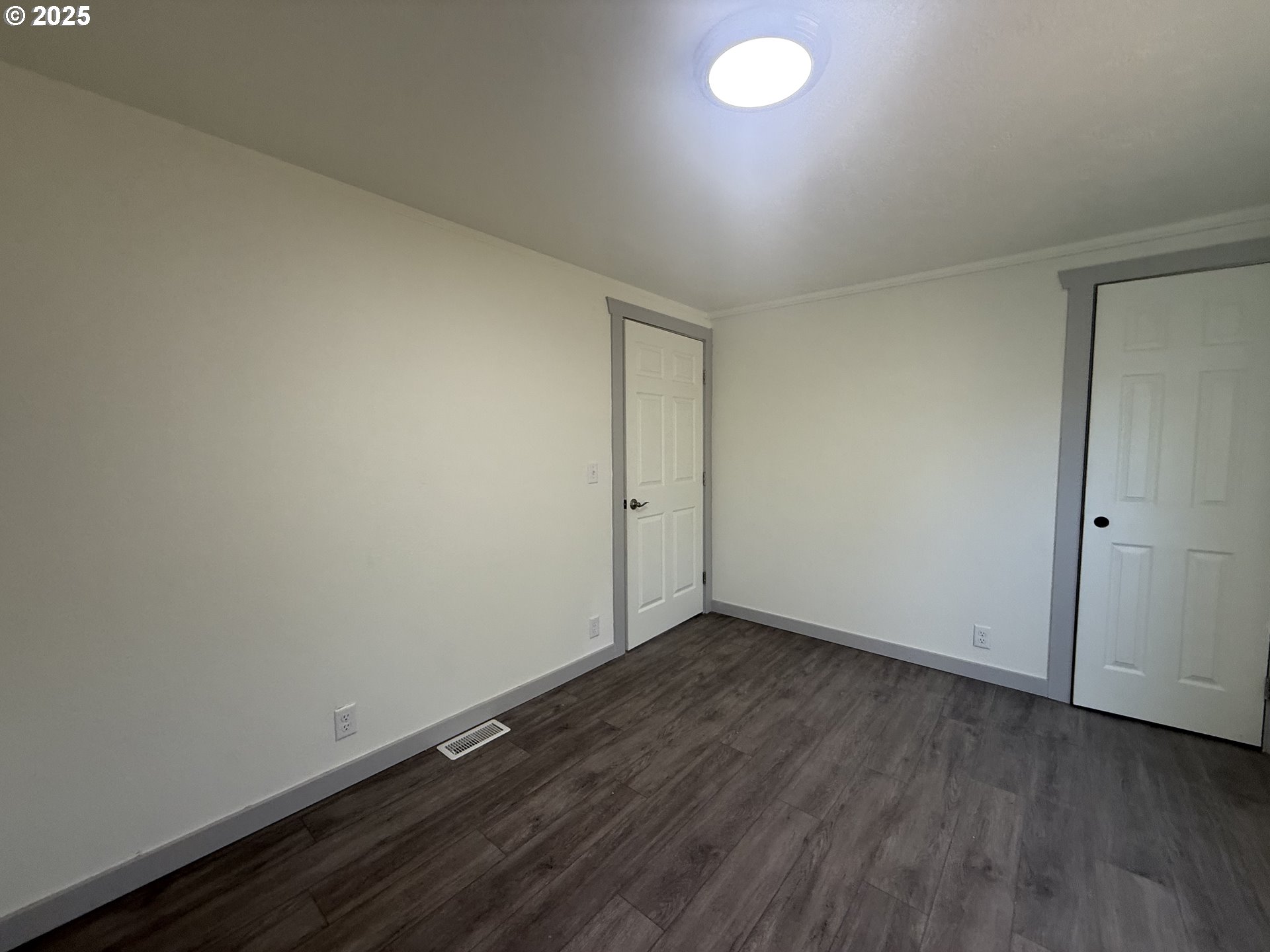 373 Hayhurst Road Yoncalla, OR 97499 - Photo 16 of 33 an empty room with wooden floor and windows