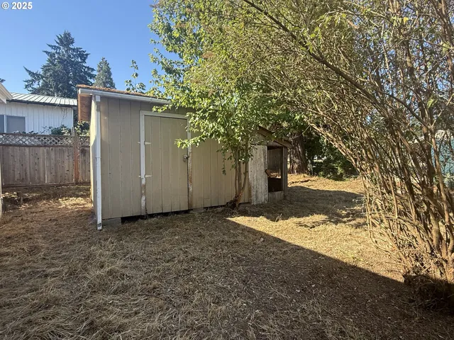 a view of a house with a tree in the background