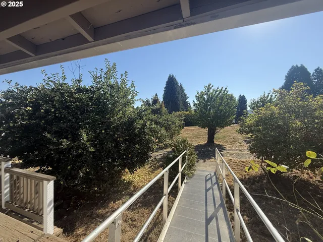a view of balcony with wooden floor and fence