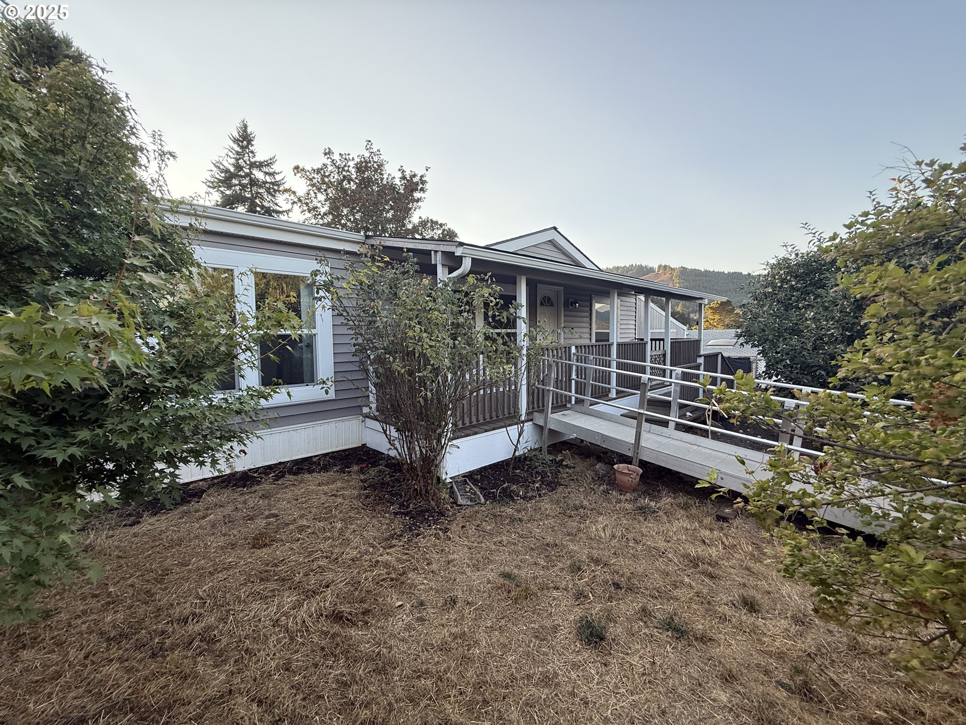 373 Hayhurst Road Yoncalla, OR 97499 - Photo 29 of 33 a view of a house with a yard and sitting area