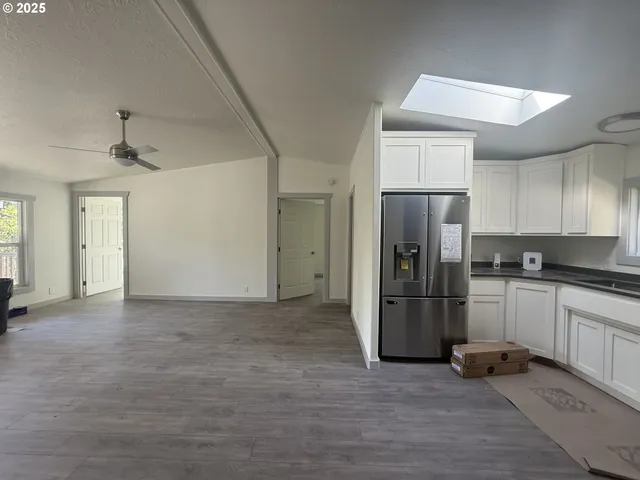 a view of a refrigerator in kitchen and wooden floor