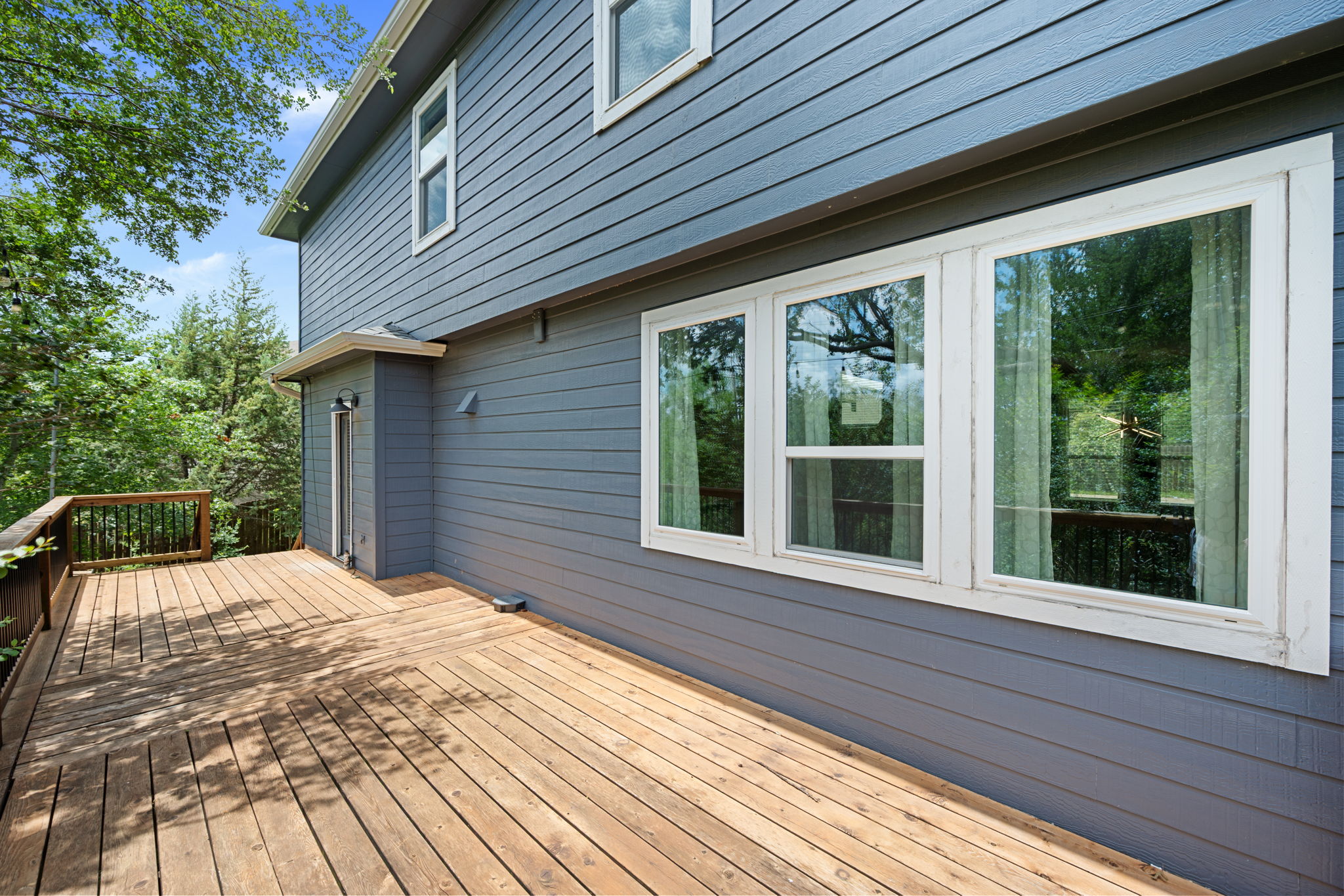 8902 Magna Carta Loop, Unit 122 Austin, TX 78754 - Photo 30 of 39 An inviting wood deck extends from the residence, ideal for tranquil outdoor moments amidst natural surroundings.