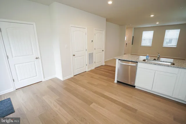 a room with a sink cabinets and wooden floor