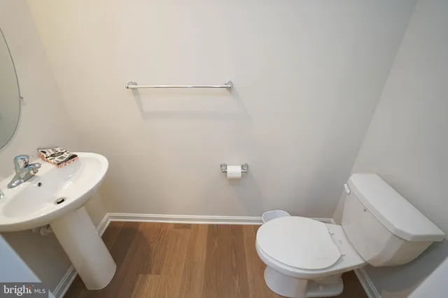 a white toilet sitting next to a bathroom sink