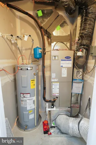 a living room with a couch and a stove next to a window