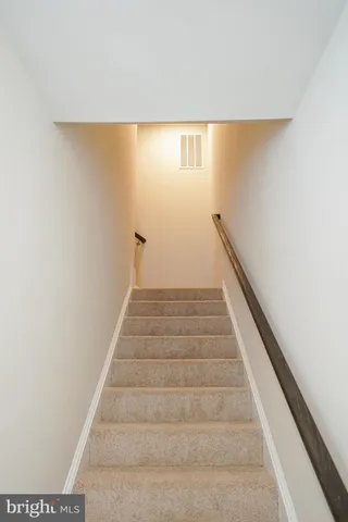 a view of a hallway with wooden floor and closet