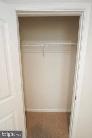 a white toilet sitting next to a bathroom sink and vanity