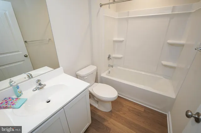 a white toilet sitting next to a bathroom sink