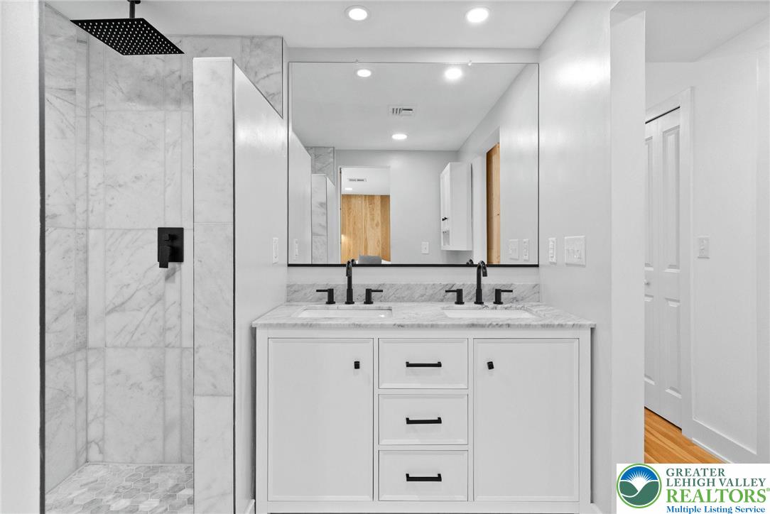 2007 Springtown Hill Road Hellertown, PA 18055 - Photo 47 of 100 a bathroom with a double vanity sink a mirror and shower