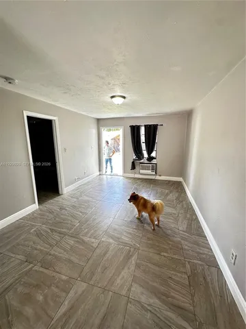 a living room with furniture and a rug