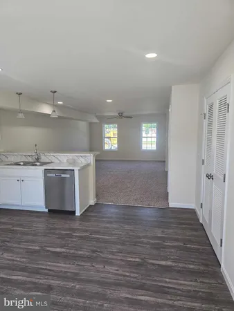 a view of a kitchen cabinets and wooden floor