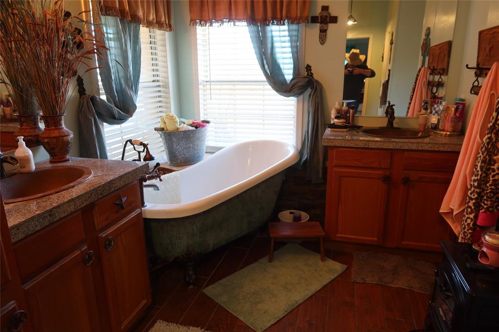 474 Hanging Tree Road Bowie, TX 76230 - Photo 15 of 27 a bathroom with mirror and vanity