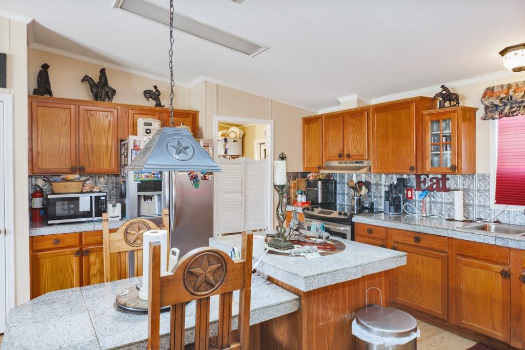 474 Hanging Tree Road Bowie, TX 76230 - Photo 2 of 27 a very nice looking dining room with a table and chairs