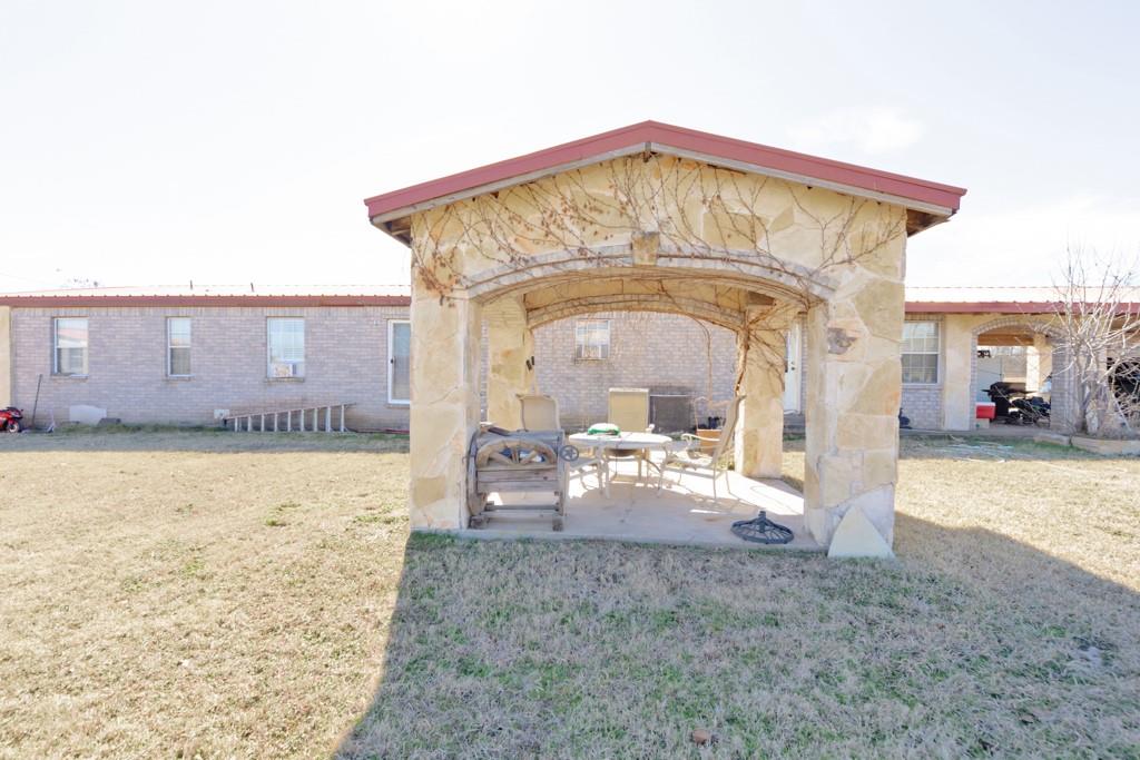 474 Hanging Tree Road Bowie, TX 76230 - Photo 23 of 27 a view of a house with backyard