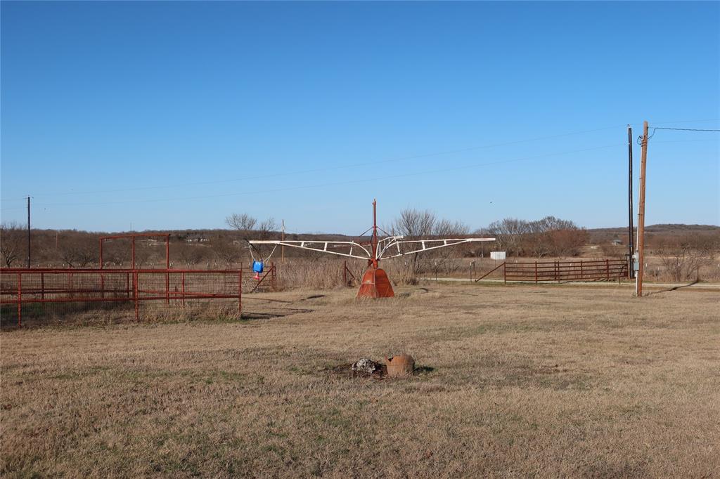 474 Hanging Tree Road Bowie, TX 76230 - Photo 24 of 27 a view of a dry yard with wooden fence