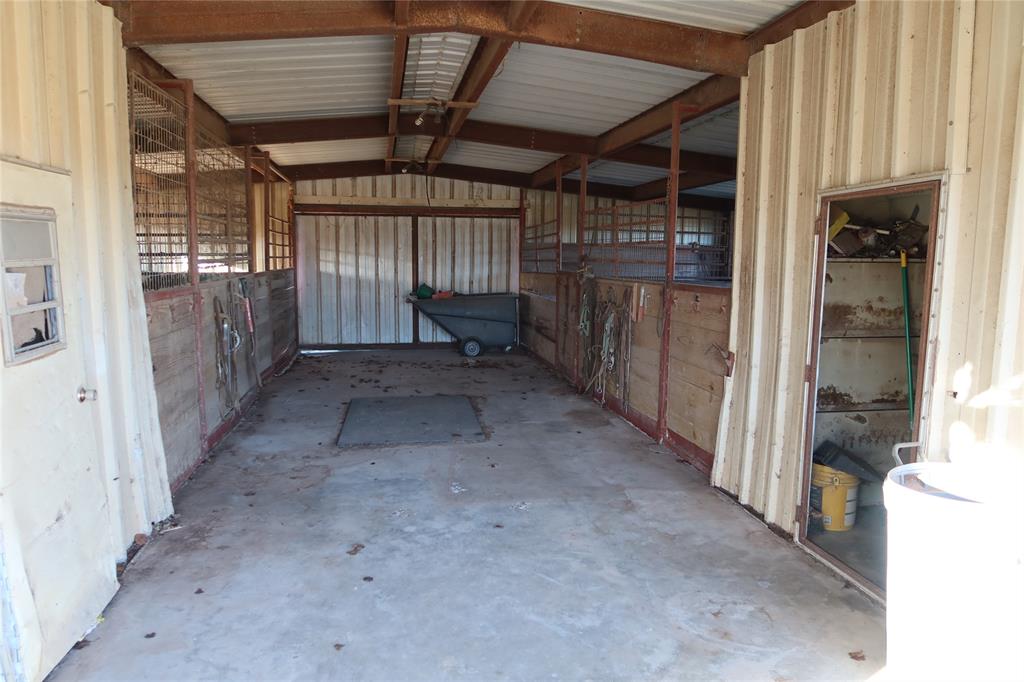 474 Hanging Tree Road Bowie, TX 76230 - Photo 26 of 27 a view of a hallway with wooden walls