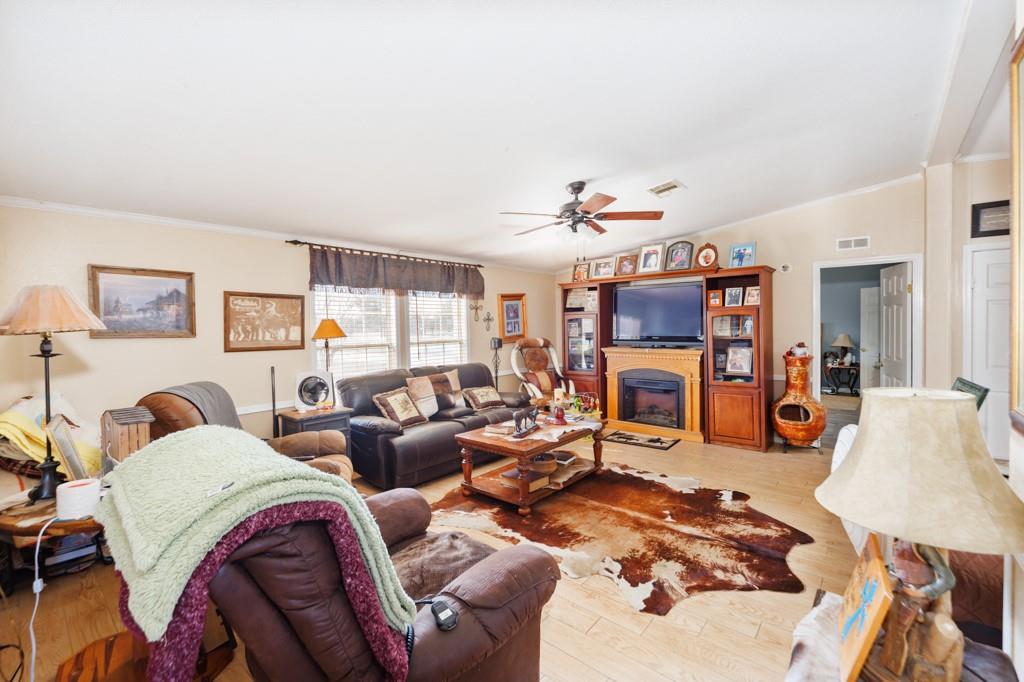 474 Hanging Tree Road Bowie, TX 76230 - Photo 3 of 27 a living room with fireplace furniture and a flat screen tv