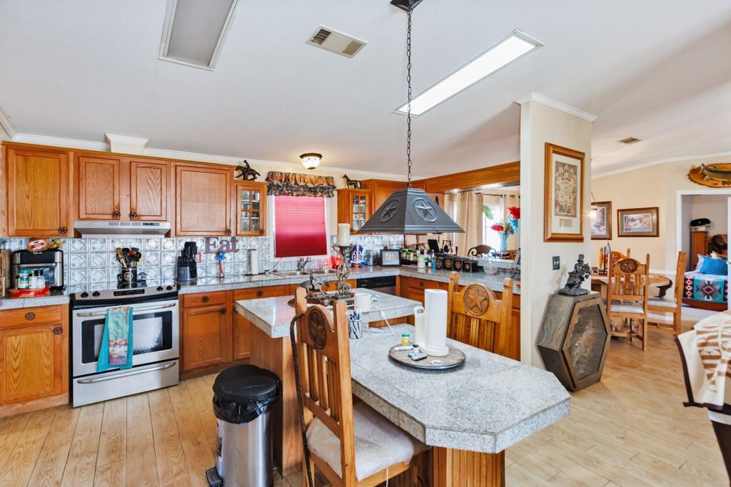 474 Hanging Tree Road Bowie, TX 76230 - Photo 4 of 27 a kitchen with stainless steel appliances granite countertop a sink a stove and refrigerator
