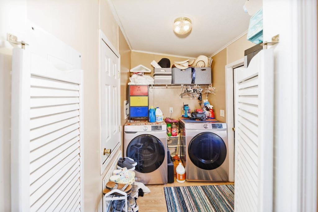 474 Hanging Tree Road Bowie, TX 76230 - Photo 6 of 27 a view of a bedroom with washer and dryer