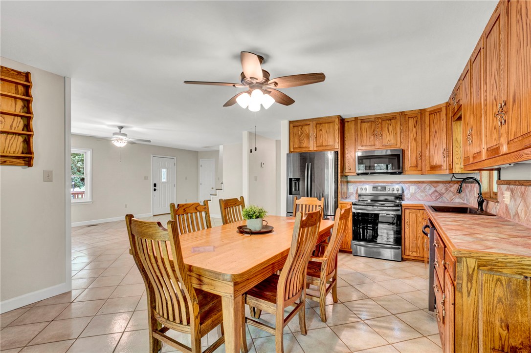 120 Patterson Ridge Road Salem, SC 29676 - Photo 11 of 46 A combined dining and cooking space with warm wood cabinetry and durable tiled countertops.