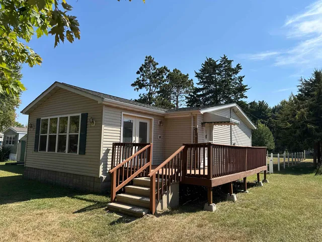 a view of a house with a yard deck and a garden