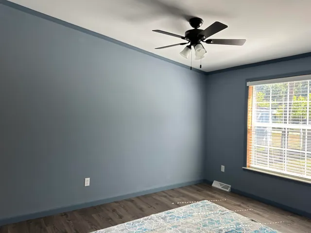 a view of a workspace with furniture and wooden floor