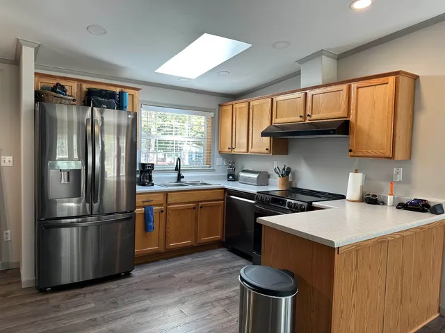 a view of a dining room with furniture and a chandelier