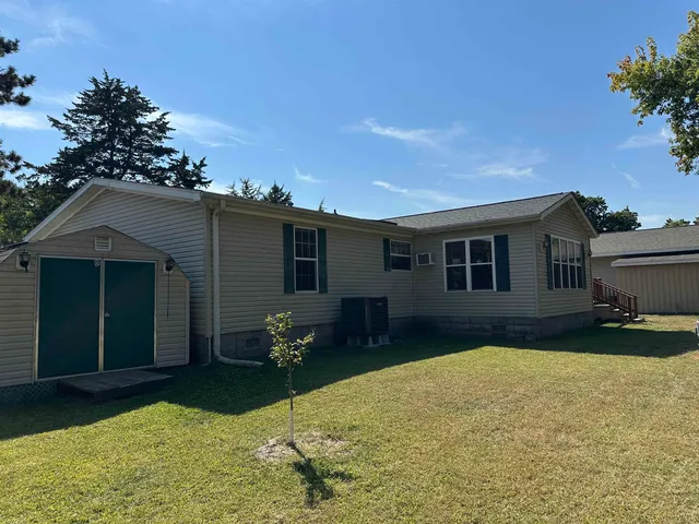 a backyard of a house with table and chairs