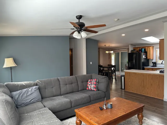 a living room with furniture a ceiling fan and a rug