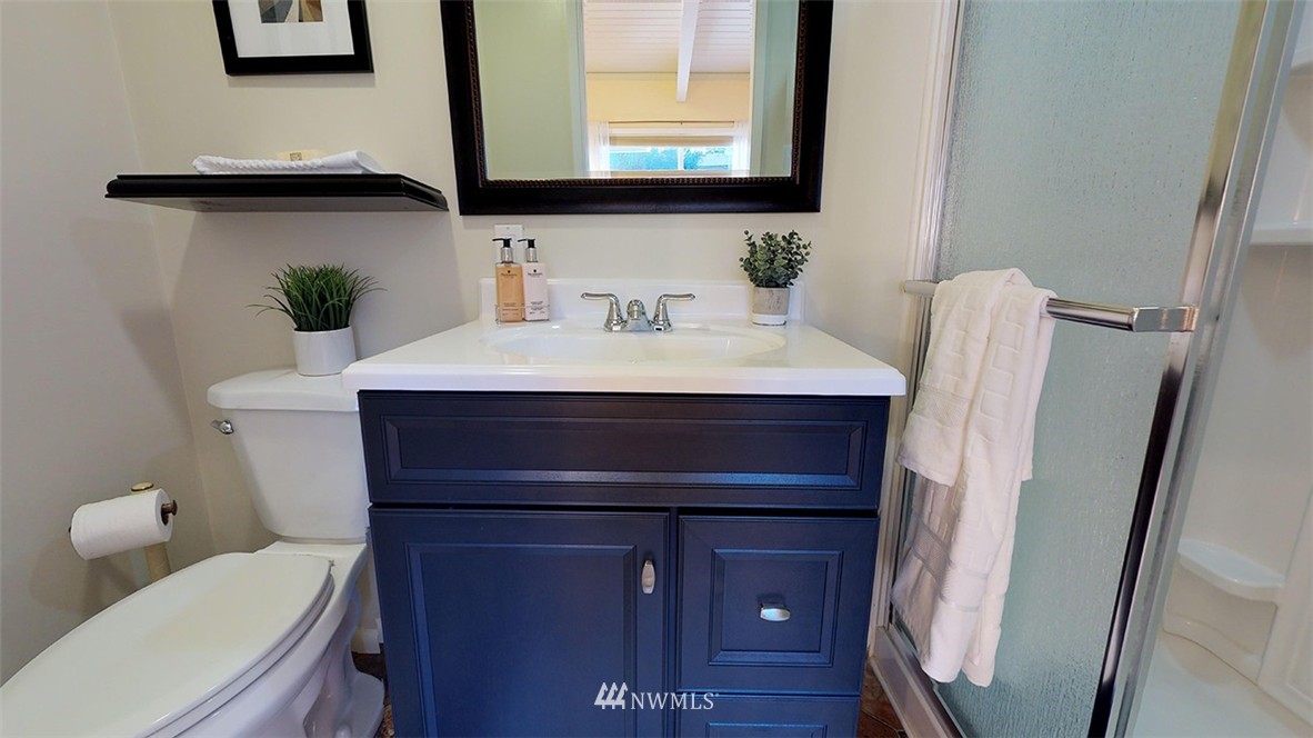 736 North 88th Street Seattle, WA 98103 - Photo 12 of 17 a bathroom with a sink vanity mirror and toilet