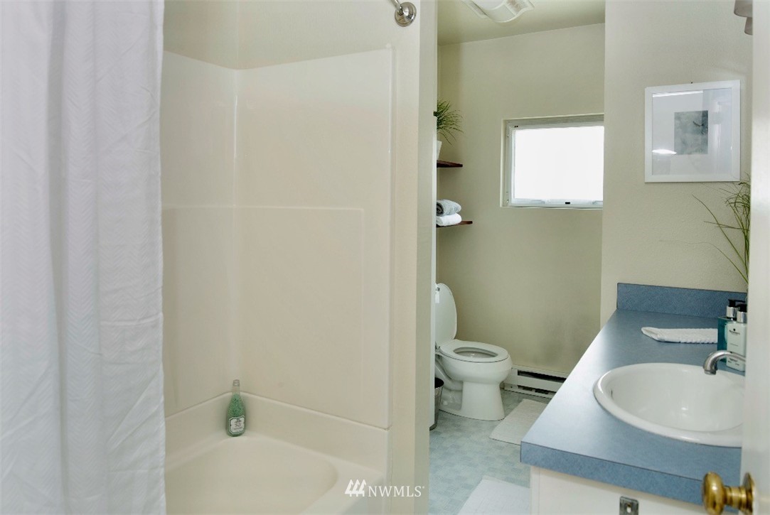 736 North 88th Street Seattle, WA 98103 - Photo 10 of 17 a bathroom with a sink a toilet and shower