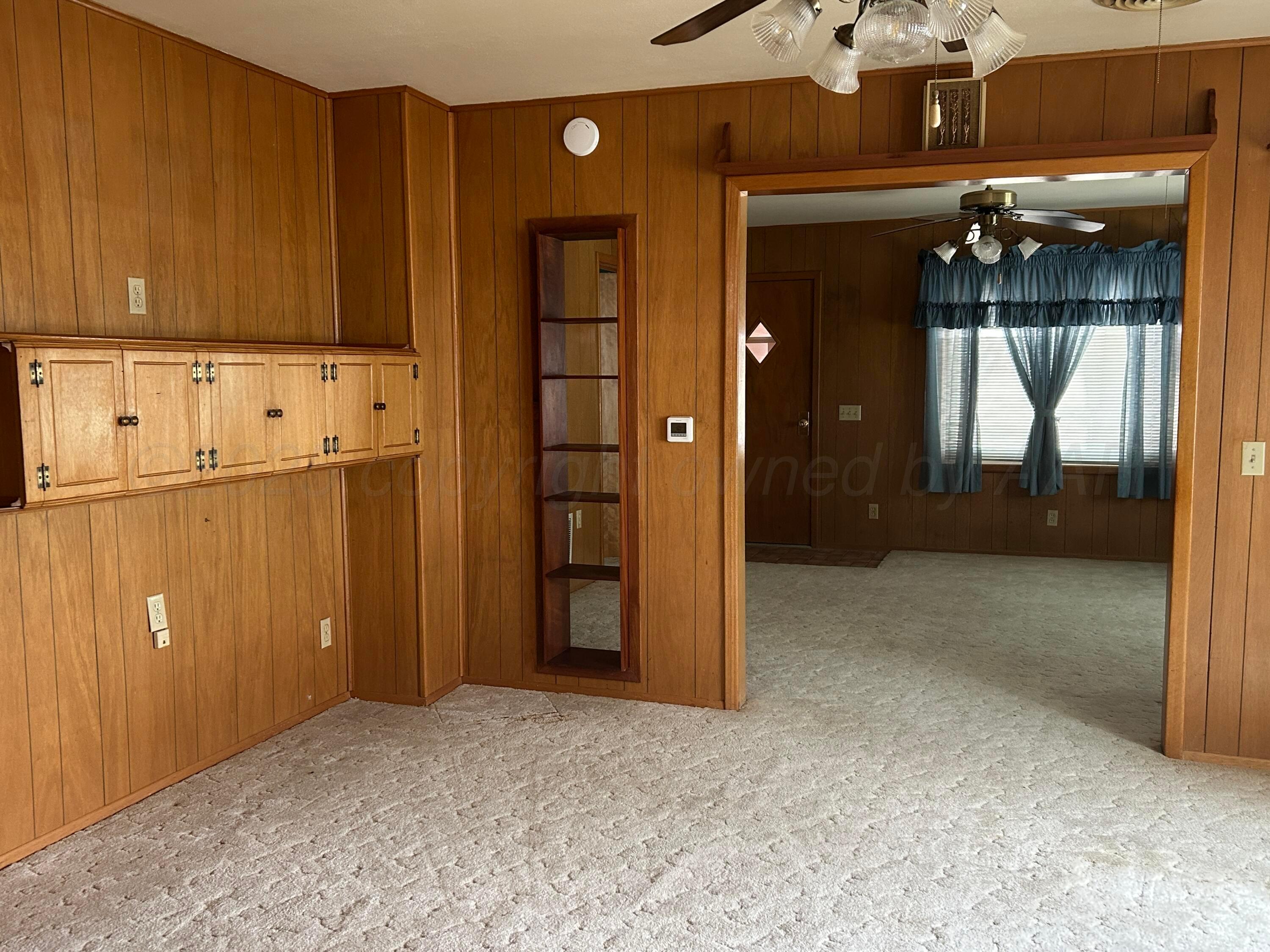 102 Willow Street Lipscomb, TX 79056 - Photo 13 of 34 an empty room with closet and wooden door