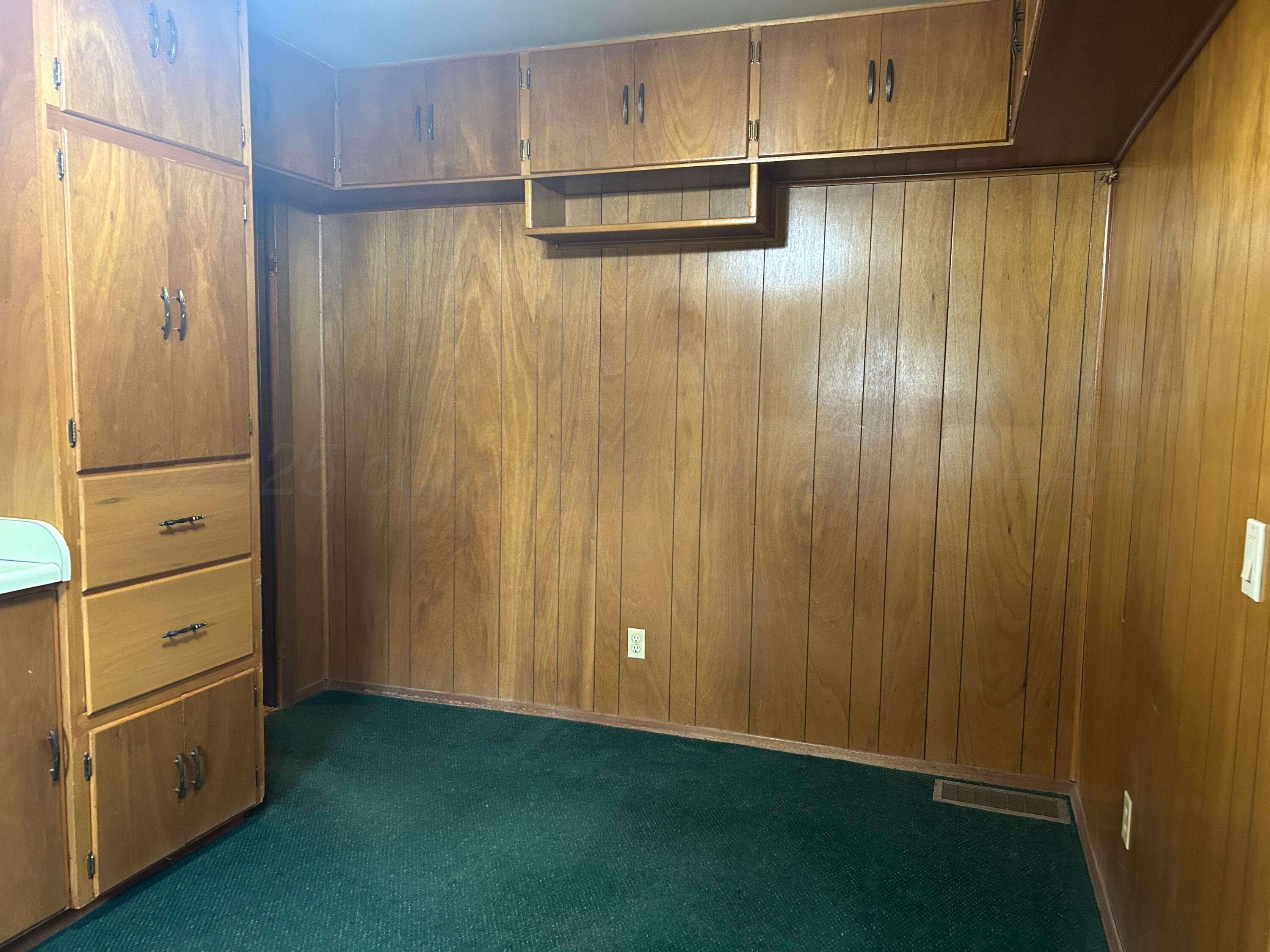 102 Willow Street Lipscomb, TX 79056 - Photo 18 of 34 a view of an empty room with cabinet and mirrors