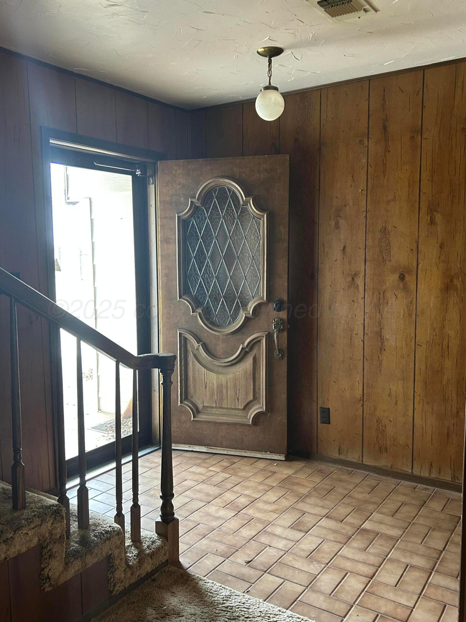 102 Willow Street Lipscomb, TX 79056 - Photo 22 of 34 a view of a hallway with wooden floor and a chandelier