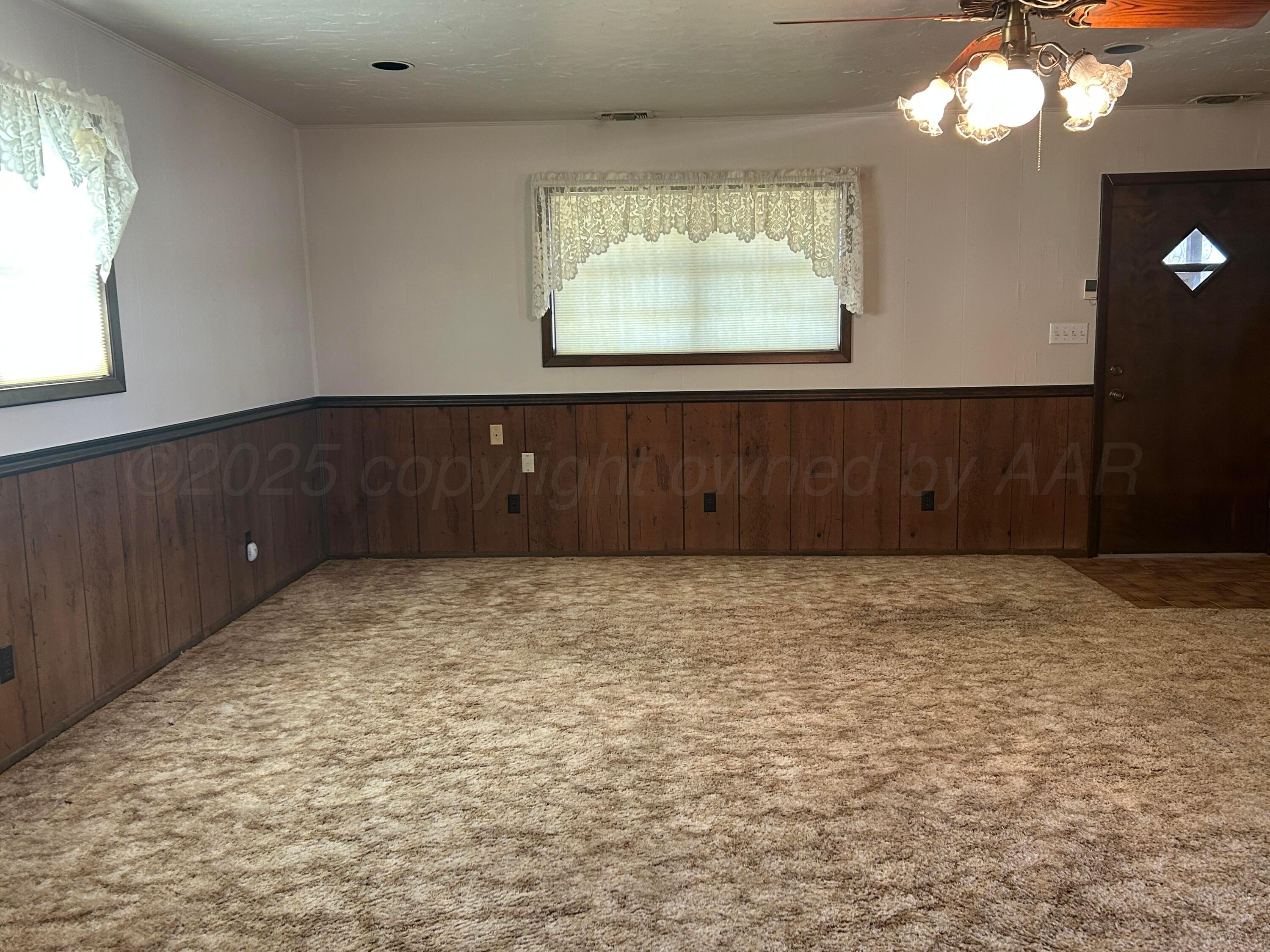 102 Willow Street Lipscomb, TX 79056 - Photo 23 of 34 a room with a fireplace and cabinets