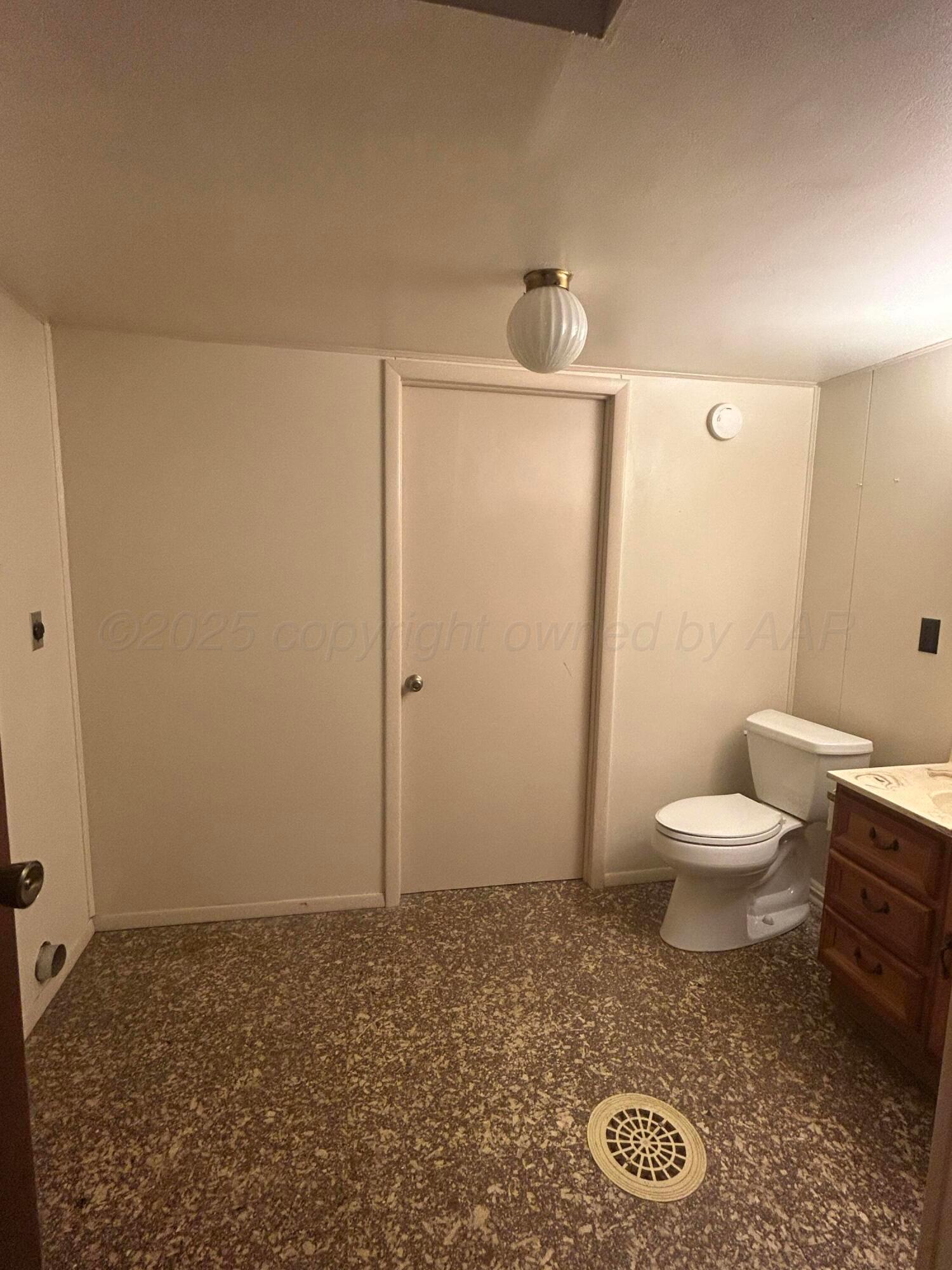 102 Willow Street Lipscomb, TX 79056 - Photo 24 of 34 a bathroom with a toilet a sink and a mirror