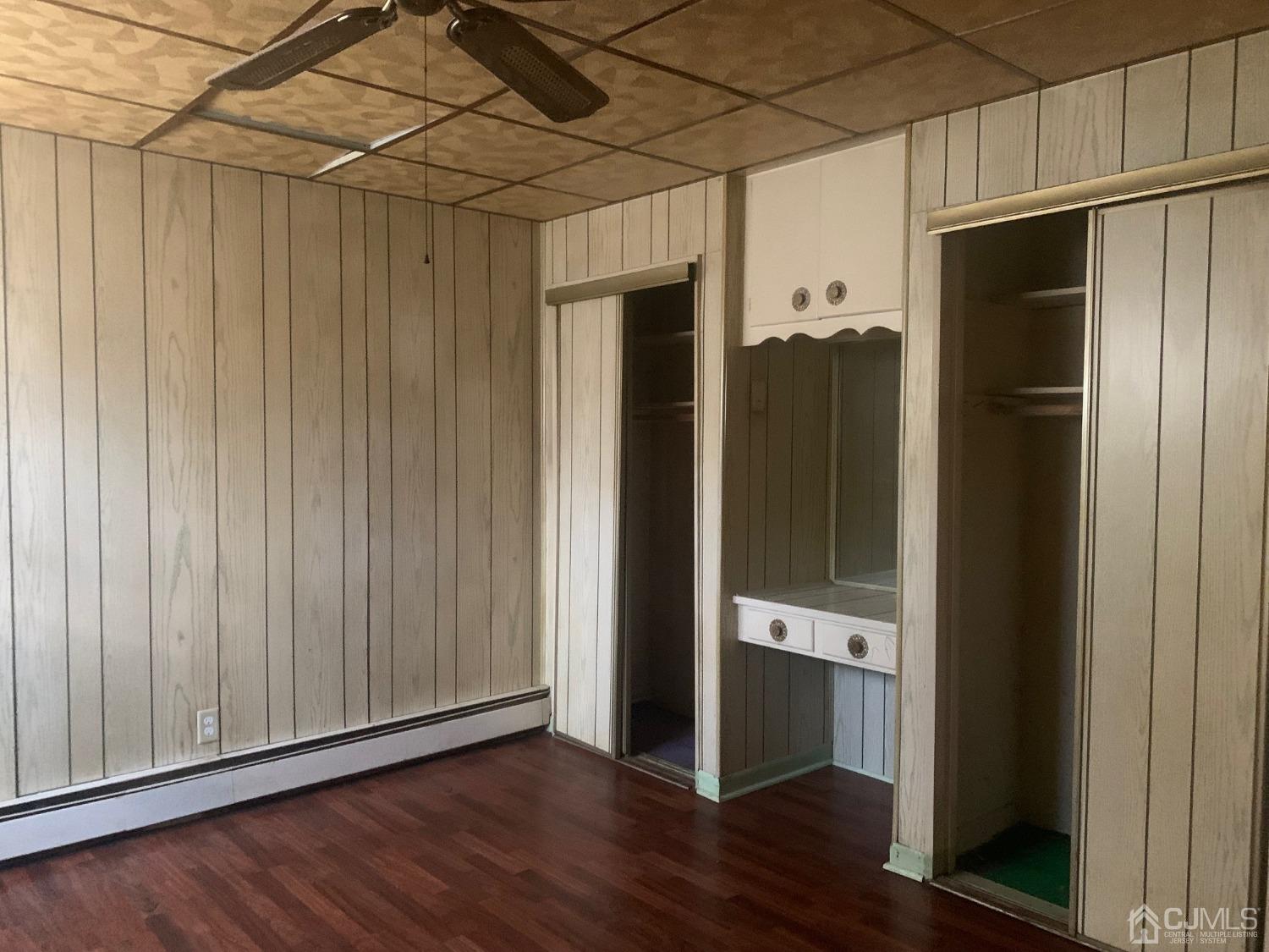 21 Fairfax Road Edison, NJ 08817 - Photo 3 of 9 a view of an empty room with wooden floor and closet area