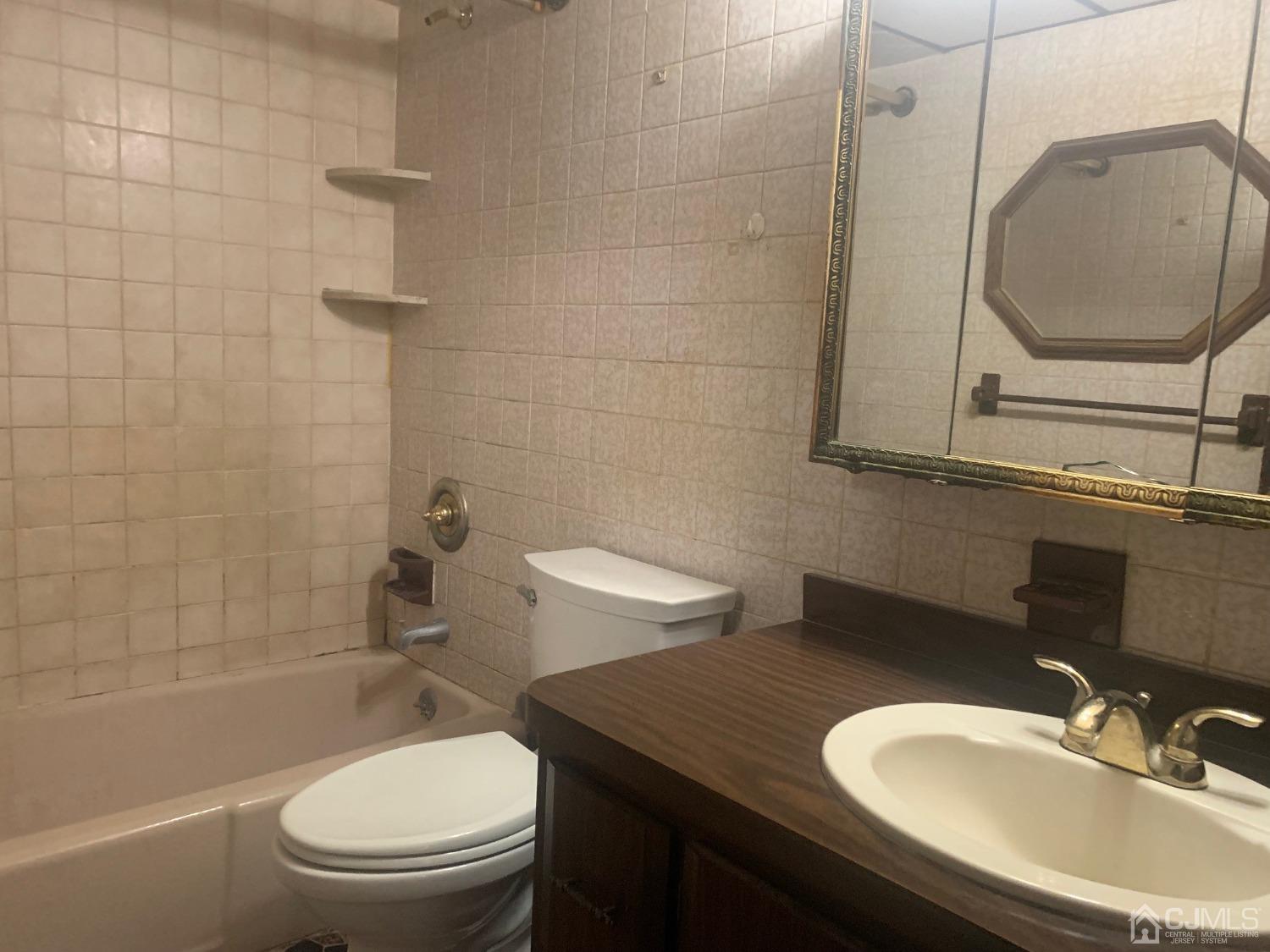 21 Fairfax Road Edison, NJ 08817 - Photo 6 of 9 a bathroom with a granite countertop toilet sink and mirror