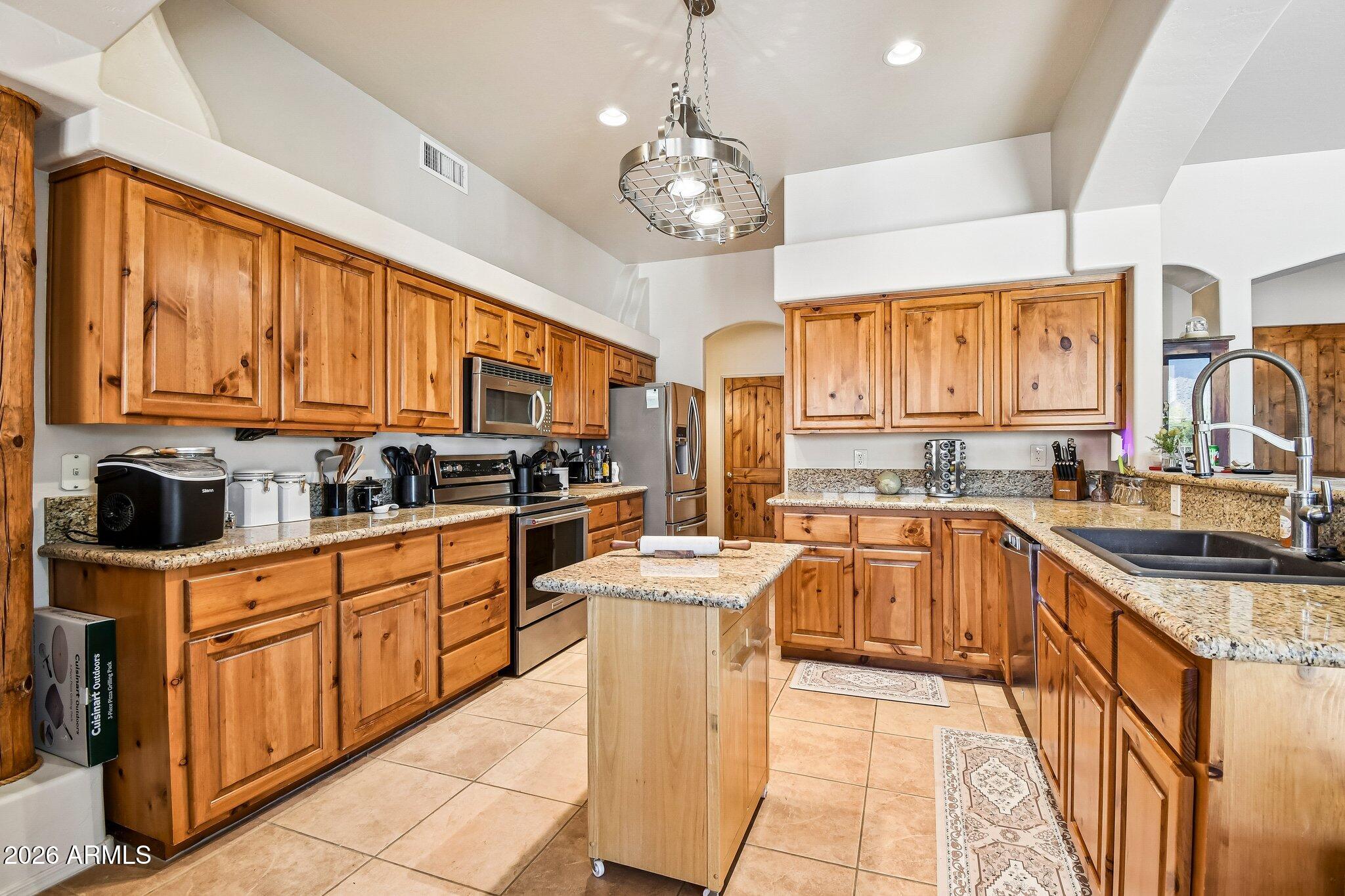 1547 North Val Vista Road Apache Junction, AZ 85119 - Photo 10 of 59 a kitchen with stainless steel appliances granite countertop a stove top oven a sink dishwasher and cabinets with wooden floor