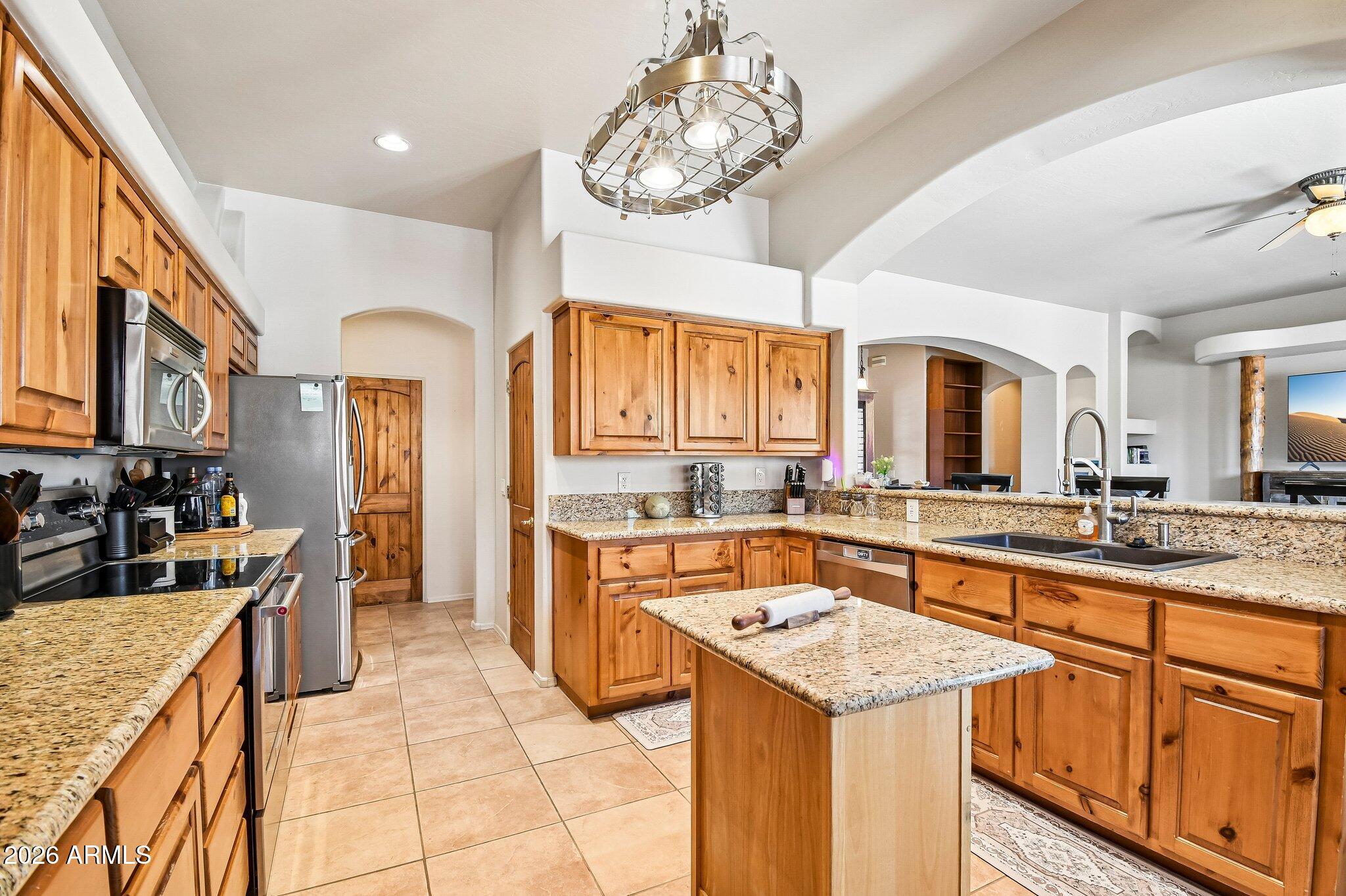 1547 North Val Vista Road Apache Junction, AZ 85119 - Photo 12 of 59 a kitchen with a stove sink and cabinets