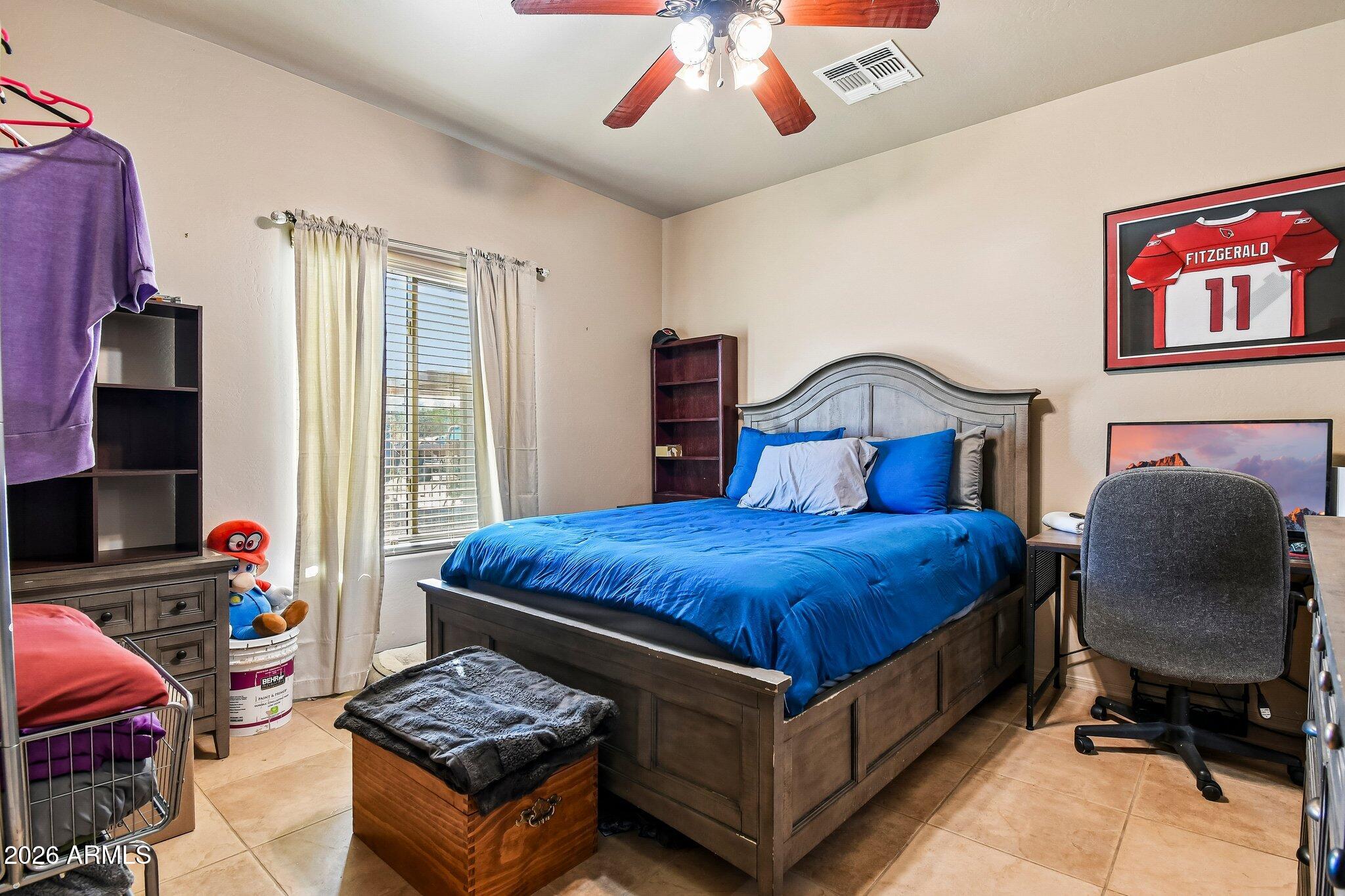 1547 North Val Vista Road Apache Junction, AZ 85119 - Photo 22 of 59 a bedroom with a bed and chair