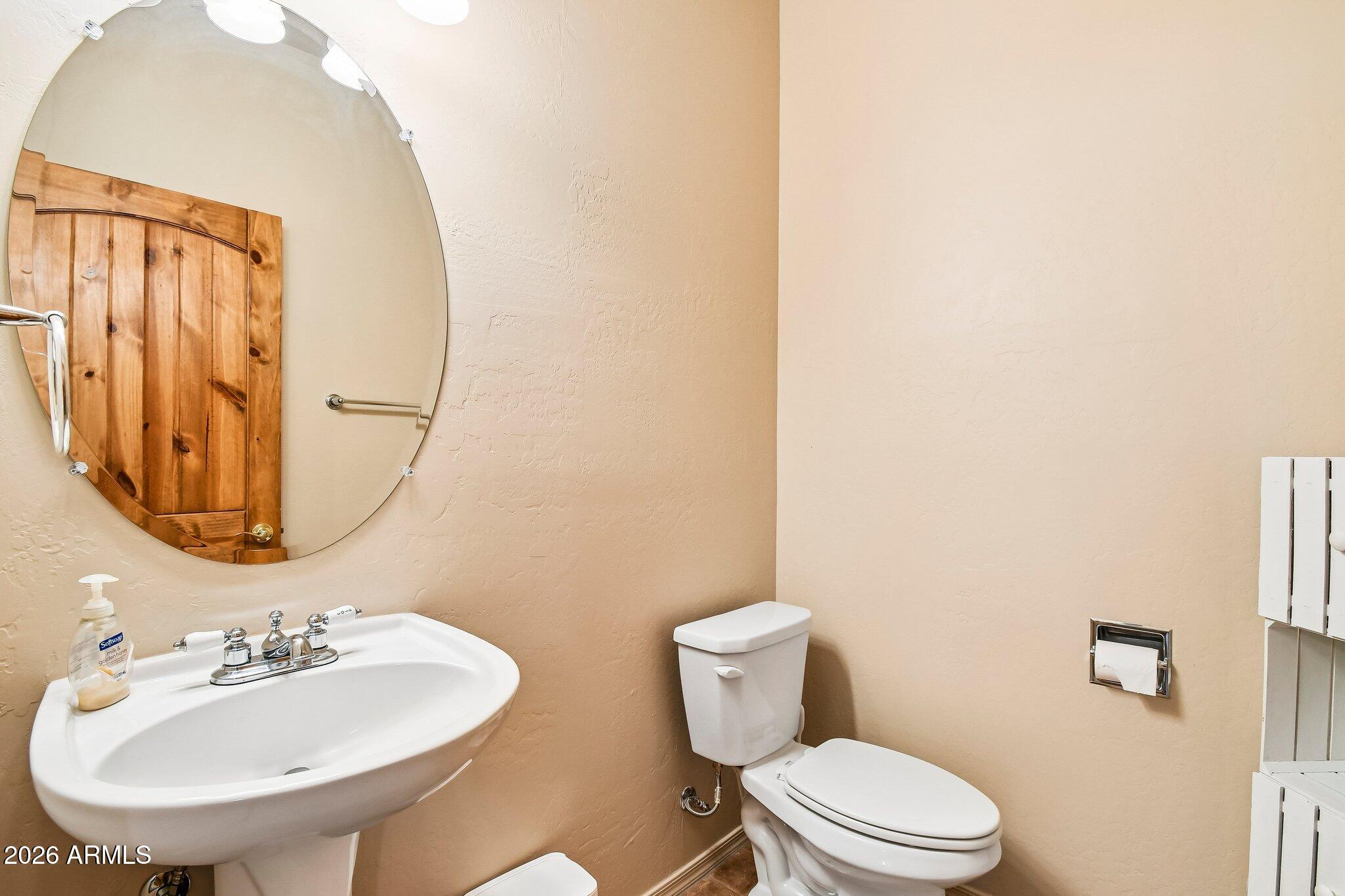 1547 North Val Vista Road Apache Junction, AZ 85119 - Photo 27 of 59 a bathroom with a toilet a sink and mirror