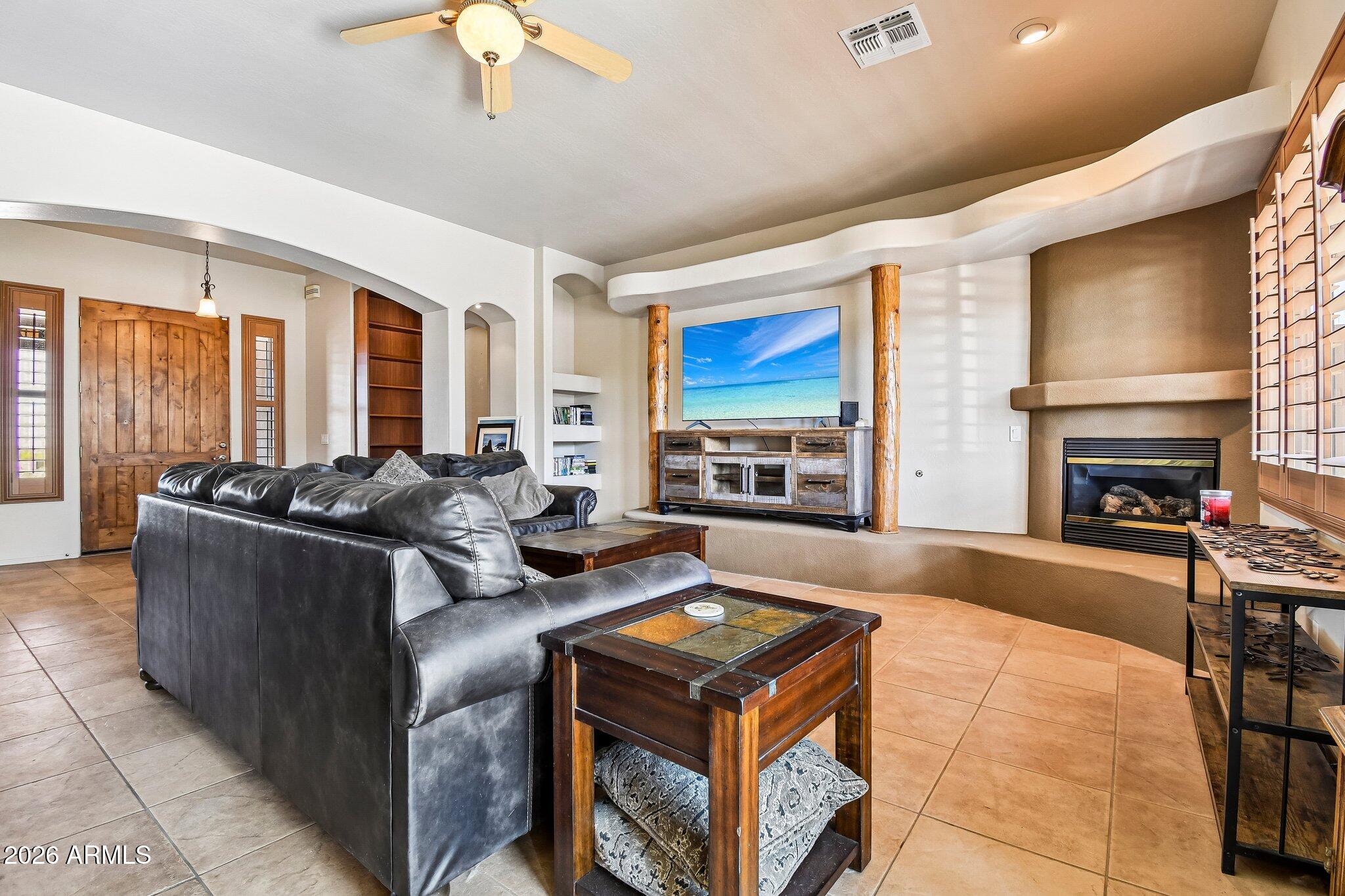 1547 North Val Vista Road Apache Junction, AZ 85119 - Photo 5 of 59 a living room with furniture a fireplace and a flat screen tv